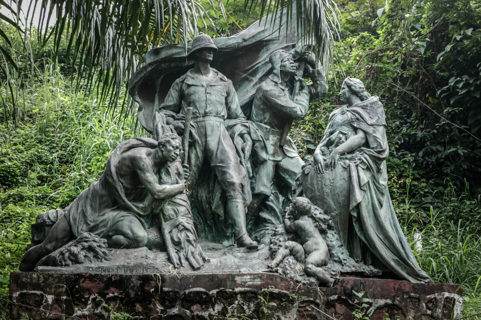 The Monument du Souvenir Congolais, a World War II memorial by Belgian sculptor Jacques Marin, depicts a Belgian Officer with a Congolese soldier and Congolese porter, at the Institute of National Museums of Congo, in the Mont Ngaliema area of the capital Kinshasa last week. Thousands of Congolese were drafted as part of the colonial armed forces, and fought during WWII in east Africa, the Middle East and Asia. Congolese soldiers, known as the Force Publique, were racially segregated and never received any compensation for their contributions to the war, according to a complaint filed in Congo in 2018 by seven children of ex-combatants. The case was in court late last year, but no judgment has been made. Kinshasa, DRC, June 2020 © Justin Makangara for Fondation Carmignac