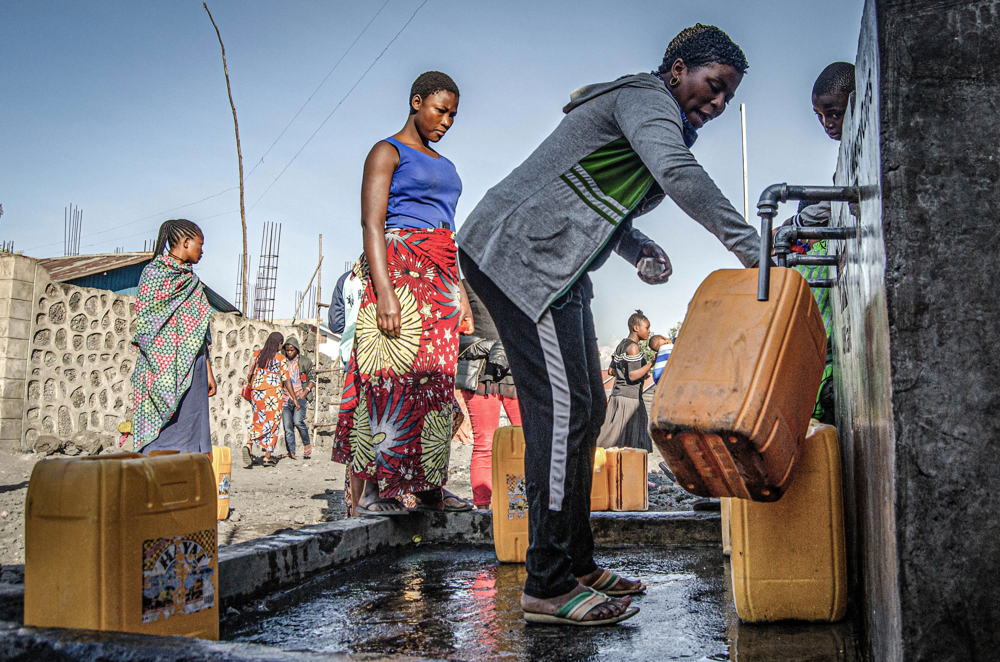 Goma, Democratic Republic of Congo, May 2020. A woman fills a water container in Goma, the capital of eastern Congo’s North Kivu Province last month. © Arlette Bashizi for Fondation Carmignac