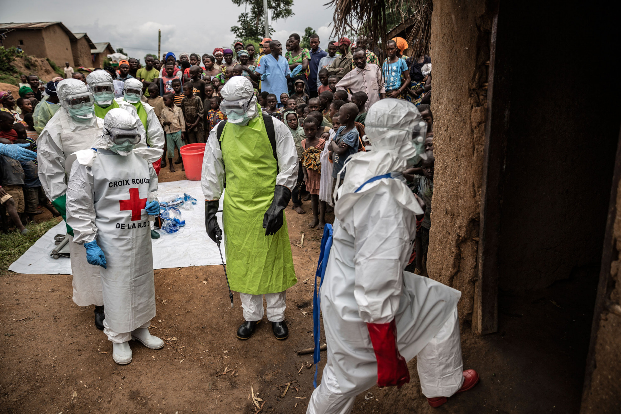 Rutshuru, province du Nord-Kivu, février 2020. Des voisins et des employés de la Croix-Rouge en tenue de protection se préparent à enterrer une enfant de 11 mois victime de l’épidémie d’Ebola. © Finbarr O’Reilly pour la Fondation Carmignac