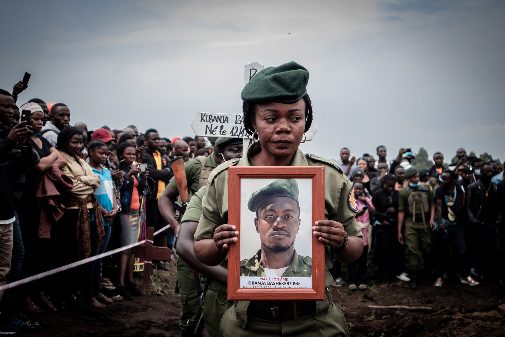 National Virunga Park, DRC, January 2021. Mourners attend the funeral of Eric Kibanja, one of six Virunga Park rangers killed in an ambush by armed attackers last month. The park has for years been the site of repeated attacks from rebels and militia groups, along with poachers and loggers, leading to the killing of hundreds of rangers. © Guerchom Ndebo for Fondation Carmignac