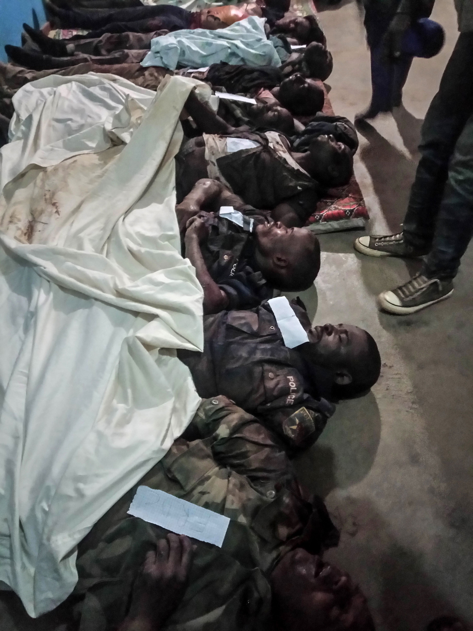 Bunia, DRC, July 2020. The bodies of three Congolese policemen and four government soldiers lie at the morgue in the city of Bunia in Congo’s northeastern Ituri Province after 11 people, including a provincial deputy and civilians, were killed by gunmen in an ambush at the village of Matete in Djugu territory on July 4. The attack was the latest blamed on assailants from the Cooperative for the Development of Congo (CODECO), an armed political-religious sect drawn from the Lendu ethnic group that has targeted rival members of the Hema community. CODECO and other Lendu fighters are accused by The Office of the UN High Commissioner for Human Rights of pursuing “a strategy of slaughtering local residents—mainly the Hema, but also the Alur—since 2017” to control natural resources in the region. © Dieudonne Dirole for Fondation Carmignac